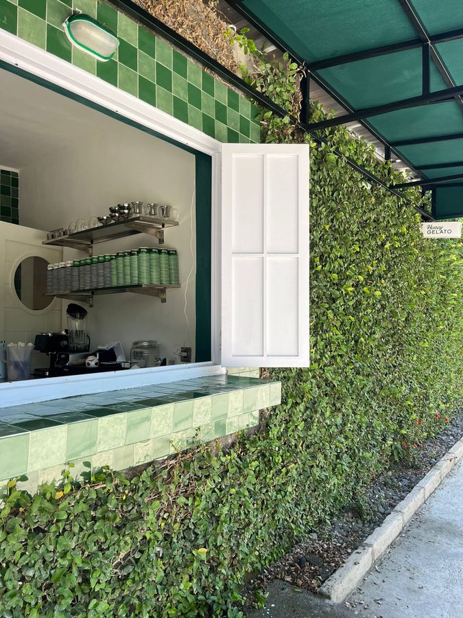 Honey Gelato serving counter with green zellige tiles and ivy-covered walls in Kuta Lombok